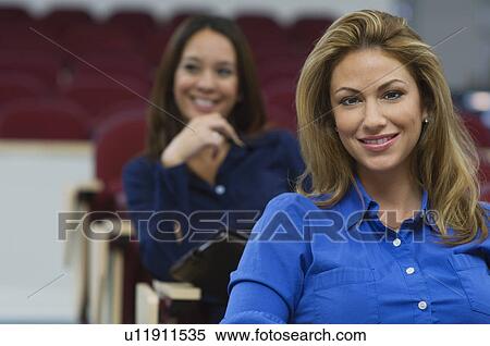 Business women sitting in auditorium View Large Photo Image Stock Photography - Business women sitting in auditorium. Fotosearch
