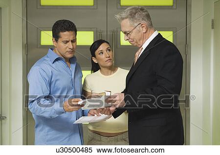 Businessman Assisting Couple View Large Photo Image Stock Photography - Businessman Assisting Couple. Fotosearch