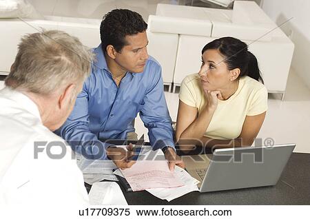 Stock Photography - Businessman Assisting Couple with Credit Cards. Fotosearch