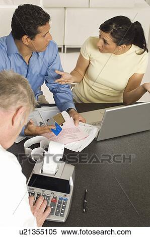 Businessman Assisting Couple with Credit Cards View Large Photo Image Stock Photography - Businessman Assisting Couple with Credit Cards. Fotosearch