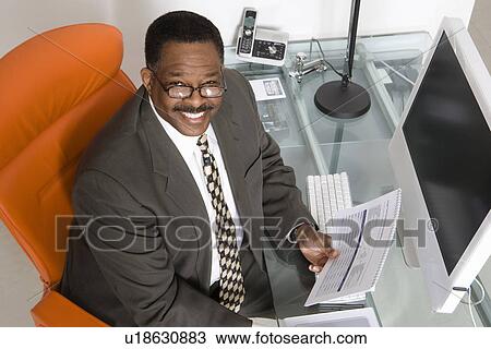 Stock Image - Businessman at His Desk. Fotosearch