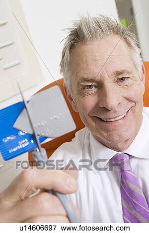 Stock Photo - Businessman Cutting Credit Card. Fotosearch