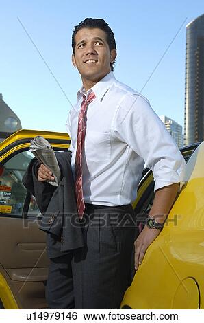 Businessman getting out of taxi View Large Photo Image Stock Photograph - Businessman getting out of taxi. Fotosearch