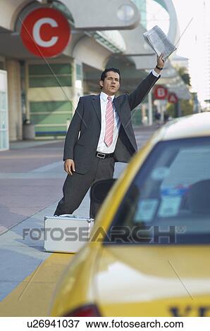 Stock Photo - Businessman hailing taxi. Fotosearch
