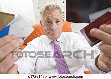 Businessman Holding Credit Cards View Large Photo Image Stock Image - Businessman Holding Credit Cards. Fotosearch