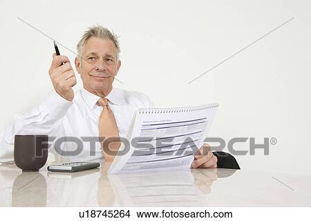 Businessman Holding Paperwork View Large Photo Image Picture - Businessman Holding Paperwork. Fotosearch