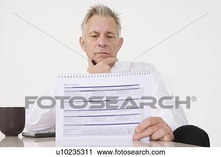 Businessman Holding Paperwork View Large Photo Image Stock Image - Businessman Holding Paperwork. Fotosearch