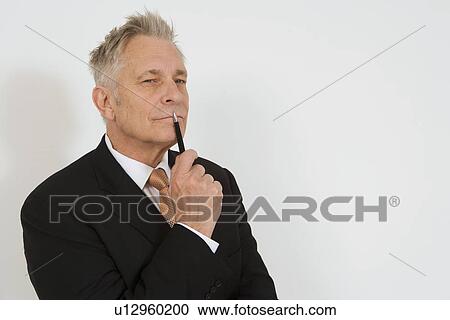 Stock Image - Businessman Holding Pen. Fotosearch