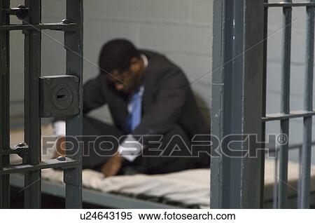 Stock Photography - Businessman in prison cell. Fotosearch