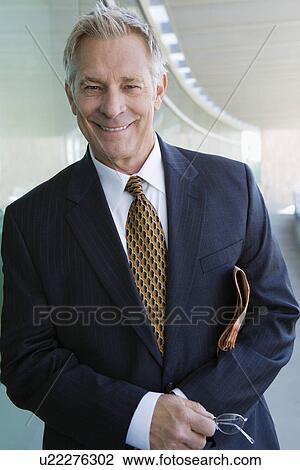 Stock Image - Businessman indoors, portrait. Fotosearch