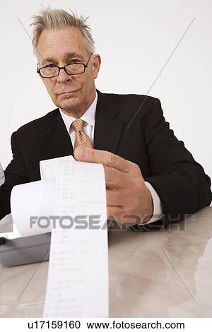 Businessman Looking at Calculator Paper View Large Photo Image Stock Image - Businessman Looking at Calculator Paper. Fotosearch