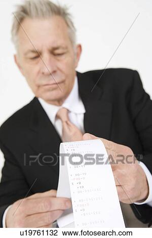 Businessman Looking at Calculator Paper View Large Photo Image Stock Image - Businessman Looking at Calculator Paper. Fotosearch