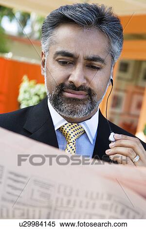 Businessman Reading a Newspaper View Large Photo Image Stock Photography - Businessman Reading a Newspaper. Fotosearch