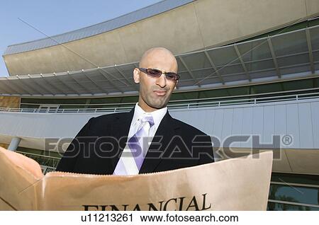 Stock Image - Businessman Reading a Paper. Fotosearch