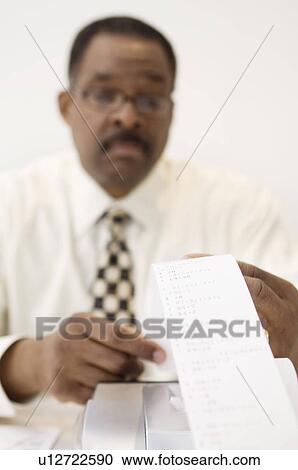 Businessman Reading an Adding Machine Tape View Large Photo Image Stock Image - Businessman Reading an Adding Machine Tape. Fotosearch