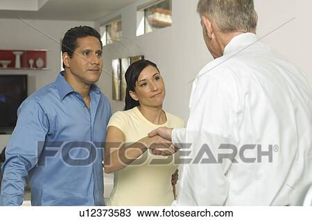 Businessman Shaking Hands with Couple View Large Photo Image Stock Image - Businessman Shaking Hands with Couple. Fotosearch
