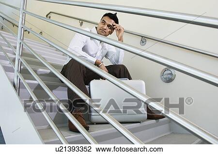 Stock Image - Businessman Sitting on a Stairway. Fotosearch