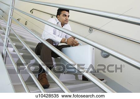 Businessman Sitting on a Stairway View Large Photo Image Stock Photography - Businessman Sitting on a Stairway. Fotosearch