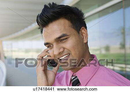 Stock Image - Businessman Talking on a Cell Phone. Fotosearch