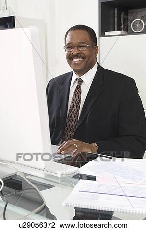 Stock Image - Businessman Using a Computer. Fotosearch