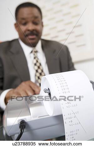 Stock Photography - Businessman Using an Adding Machine. Fotosearch