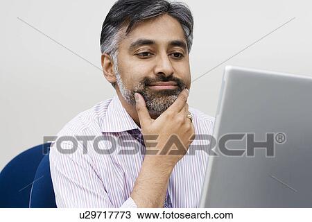Stock Image - Businessman Using Laptop. Fotosearch
