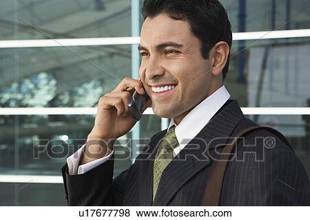 Stock Photo - Businessman using mobile phone outdoors. Fotosearch
