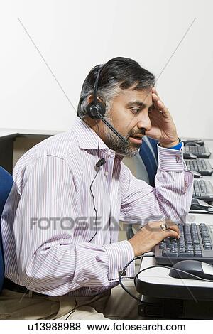 Stock Photo - Businessman Using Telephone Headset. Fotosearch