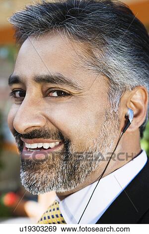 Stock Photo - Businessman with an Earbud. Fotosearch