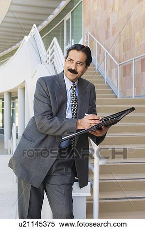 Stock Photography - Businessman with Daily Organizer. Fotosearch