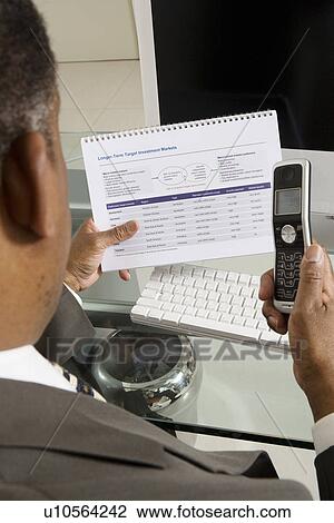 Businessman with Investment Brochure and Cell Phone View Large Photo Image Stock Image - Businessman with Investment Brochure and Cell Phone. Fotosearch