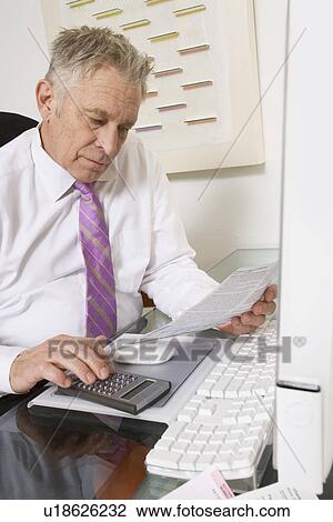 Stock Image - Businessman Working at Desk. Fotosearch