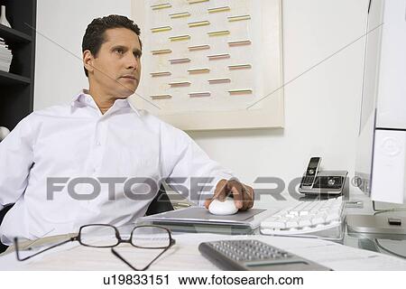 Stock Image - Businessman Working at Desk. Fotosearch