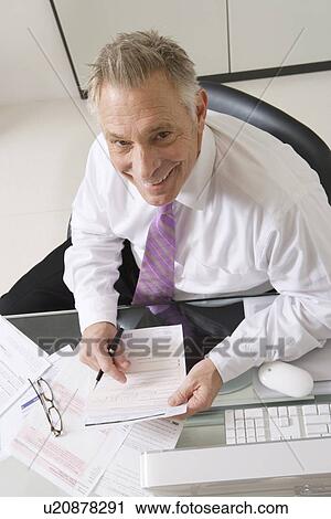 Stock Image - Businessman Working at Desk. Fotosearch