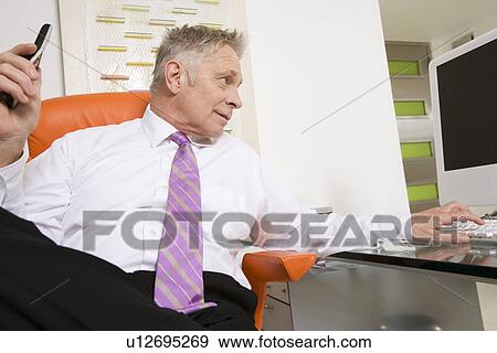 Businessman Working at Desk View Large Photo Image Stock Photo - Businessman Working at Desk. Fotosearch