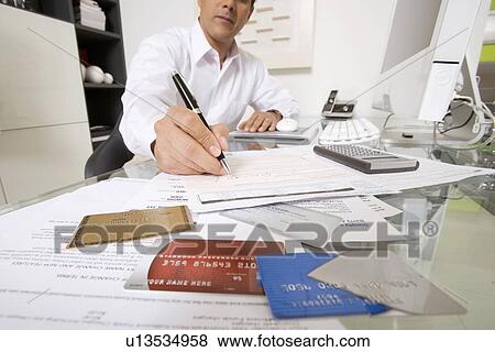 Stock Photo - Businessman Working at Desk. Fotosearch