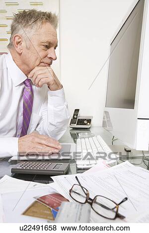 Stock Photo - Businessman Working at Desk. Fotosearch
