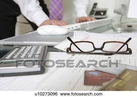 Stock Photograph - Businessman Working at Desk. Fotosearch