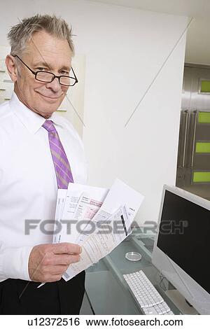 Stock Photograph - Businessman Working at Desk. Fotosearch