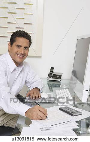 Stock Photography - Businessman Working at Desk. Fotosearch