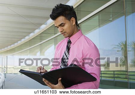 Businessman Writing in a Planner View Large Photo Image Stock Image - Businessman Writing in a Planner. Fotosearch