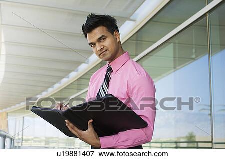 Businessman Writing in a Planner View Large Photo Image Stock Photo - Businessman Writing in a Planner. Fotosearch