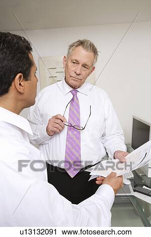 Stock Image - Businessmen Working in Office. Fotosearch