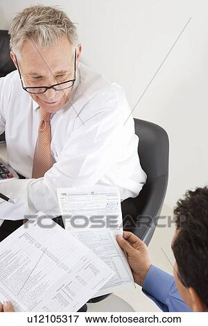 Stock Photo - Businessmen Working in Office. Fotosearch