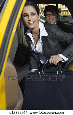 Businesswoman getting out of taxi View Large Photo Image Stock Image - Businesswoman getting out of taxi. Fotosearch