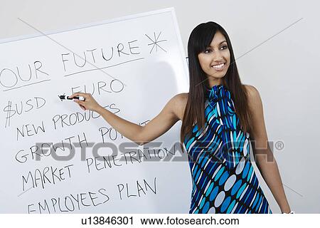 Stock Image - Businesswoman Presenting Company Goals. Fotosearch