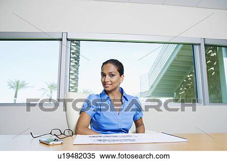 Stock Photography - Businesswoman Sitting at Table. Fotosearch