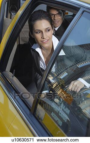Businesswoman sitting in taxi and looking out window View Large Photo Image Stock Image - Businesswoman sitting in taxi and looking out window. Fotosearch