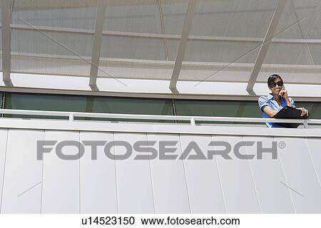 Stock Image - Businesswoman Using Cell Phone. Fotosearch