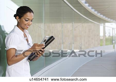 Stock Image - Businesswoman Using Cell Phone. Fotosearch